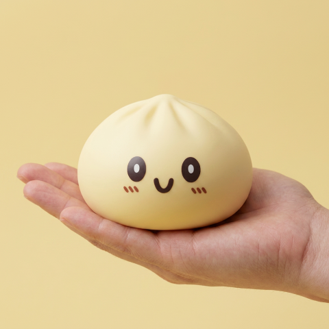 Jumbo Giant Yellow Dumpling Squishy held in hand, actual size
