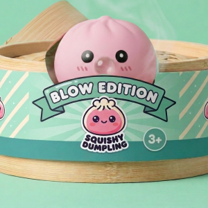 Soft Pink Dumpling Squishy in its bamboo steamer box