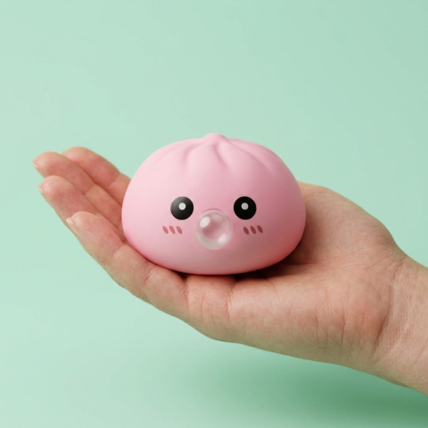 Soft Pink Dumpling Squishy held in hand, actual size