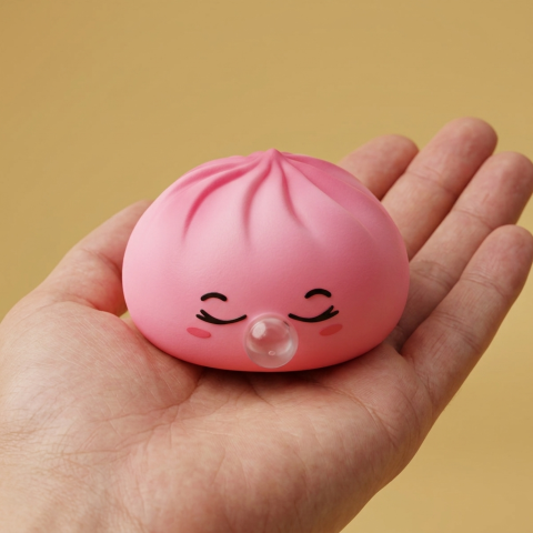 Pink Rare Blow Dumpling Squishy held in hand, actual size