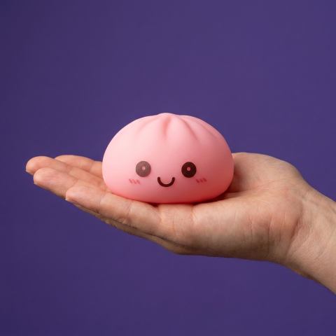 Pink Dumpling Squishy Night Light held in hand, actual size