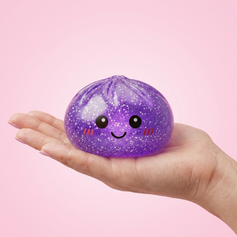 Dreamy Purple Glitter Dumpling Squishy held in hand, actual size