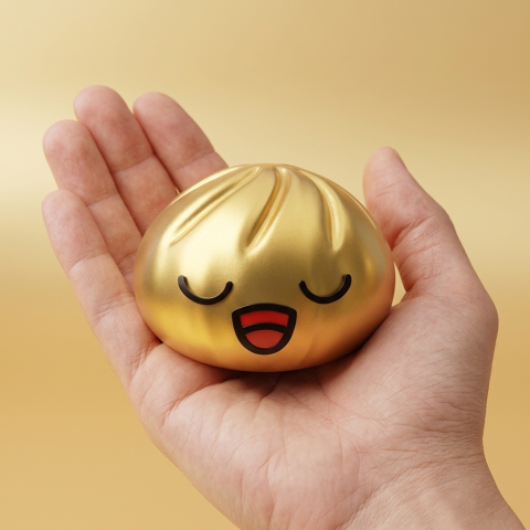 Rare Gold Treasure Dumpling Squishy held in hand, actual size