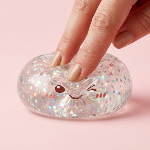 Silver Glitter Dumpling Squishy being squeezed, soft slow-rise foam