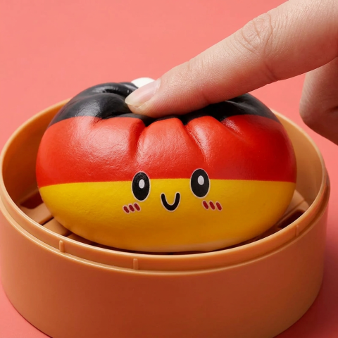 Germany Flag Dumpling Squishy Toy being squeezed, soft slow-rise foam