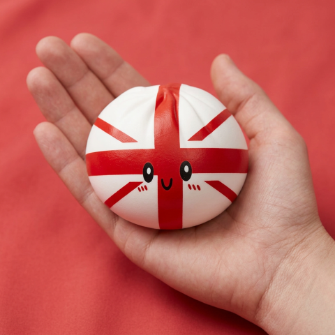 UK Flag Dumpling Squishy Toy held in hand, actual size