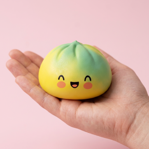Yellow Fade Dumpling Squishy held in hand, actual size