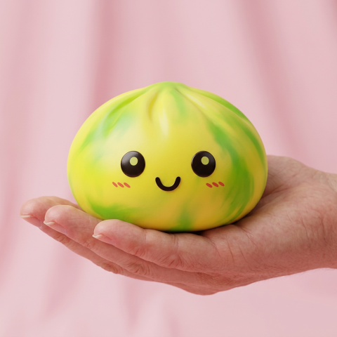 Yellow Tie Dye Dumpling Squishy held in hand, actual size