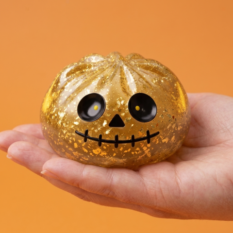 Gold Glitter Zombie Halloween Dumpling Squishy held in hand, actual size