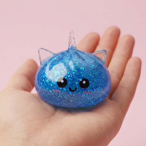 Blue Unicorn Glitter Dumpling Squishy held in hand, actual size