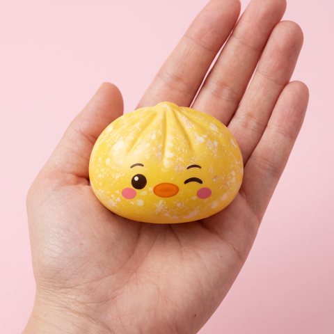 Buttercup Yellow Penguin Dumpling Squishy held in hand, actual size