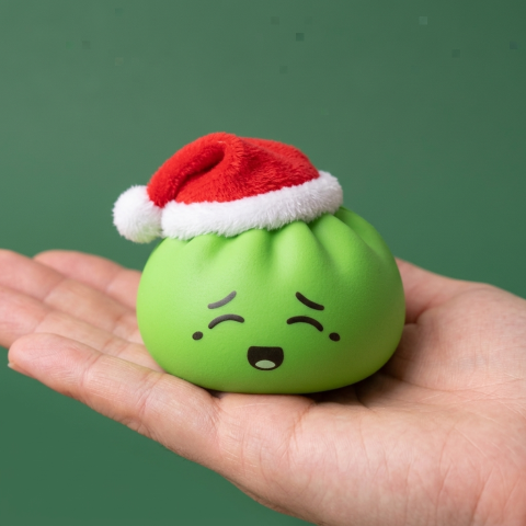 Elf Green Christmas Hat Dumpling Squishy held in hand, actual size
