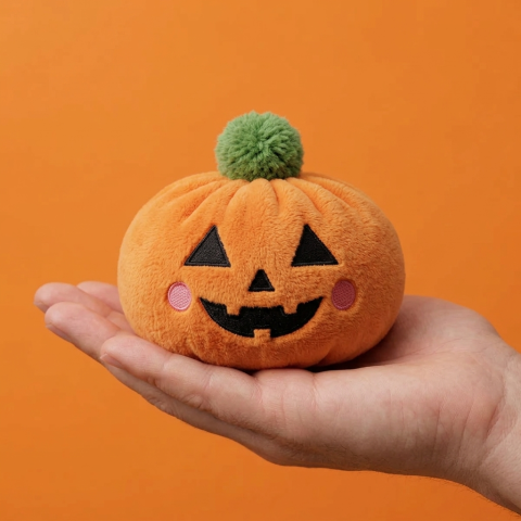 Pumpkin Halloween Dumpling Squishy held in hand, actual size