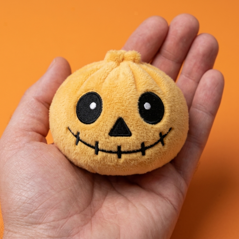Halloween Skeleton Dumpling Squishy held in hand, actual size
