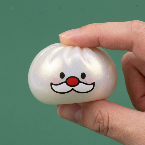 Santa Moustache Mystery Dumpling Squishy being squeezed, soft slow-rise foam