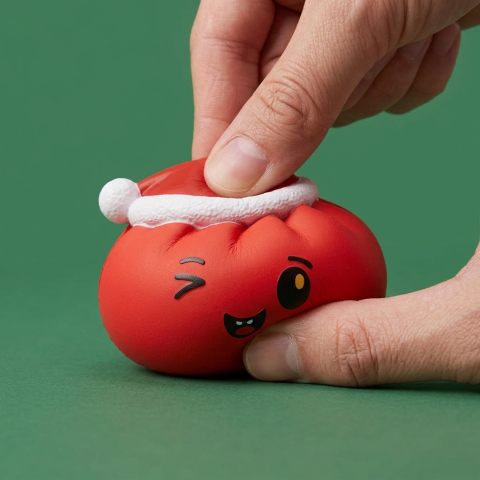 Red Christmas Hat Dumpling Squishy being squeezed, soft slow-rise foam
