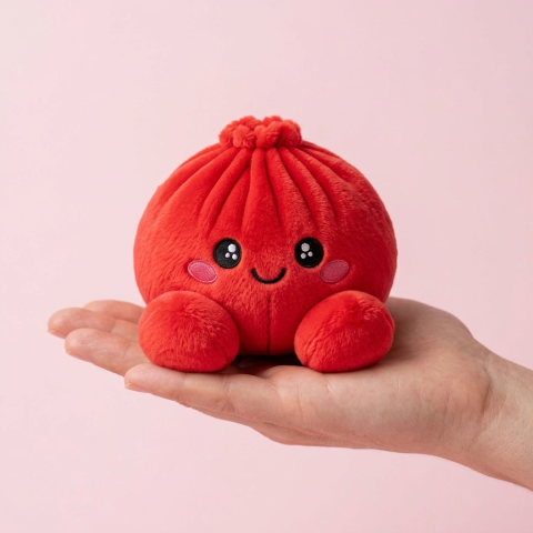 Ruby Red Dumpling Squishy Plush held in hand, actual size