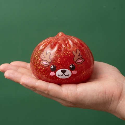Red Reindeer Glitter Dumpling Squishy held in hand, actual size