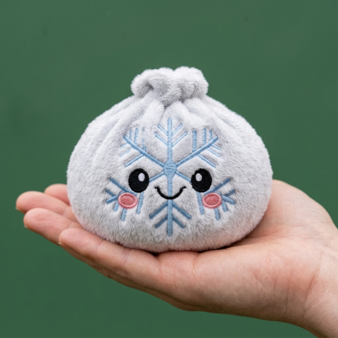 Winter Snowflake Dumpling Squishy Plush held in hand, actual size