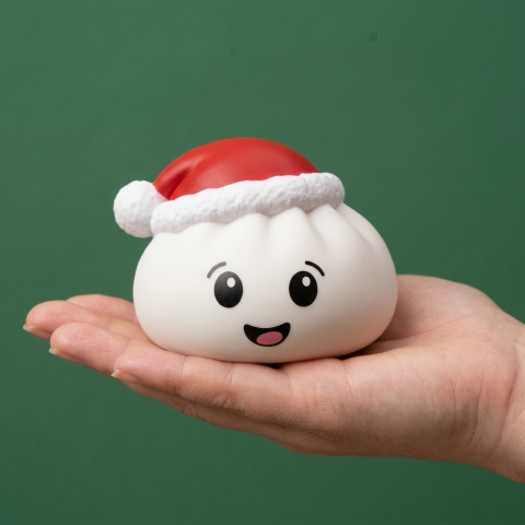White Christmas Hat Dumpling Squishy held in hand, actual size
